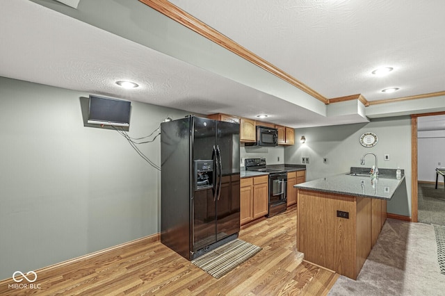 3766 Brill Rd, Indianapolis, IN 46227 - kitchen with black appliances, crown molding, a peninsula, a kitchen bar, and light wood-style floors