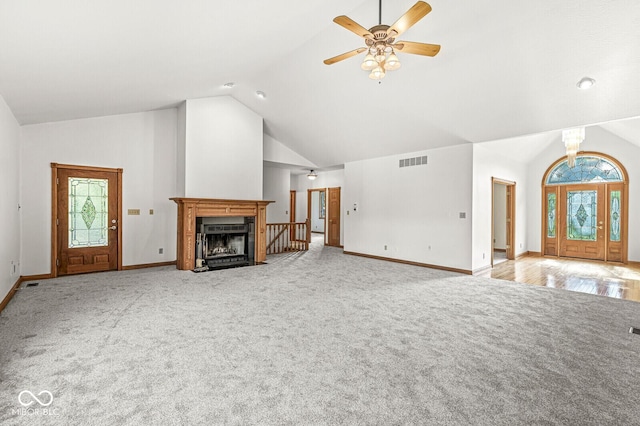 3766 Brill Rd, Indianapolis, IN 46227 - unfurnished living room featuring plenty of natural light, a fireplace with flush hearth, high vaulted ceiling, light carpet, and ceiling fan