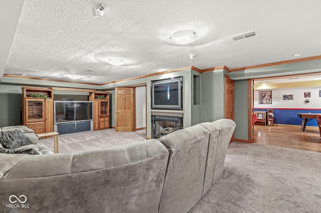 3766 Brill Rd, Indianapolis, IN 46227 - living room featuring crown molding, carpet flooring, a fireplace, and a textured ceiling