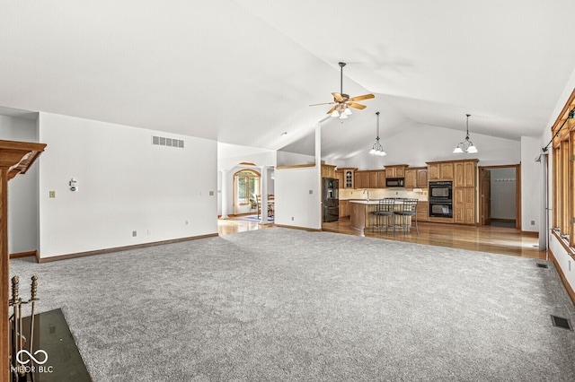 3766 Brill Rd, Indianapolis, IN 46227 - unfurnished living room featuring light colored carpet, a ceiling fan, arched walkways, and high vaulted ceiling