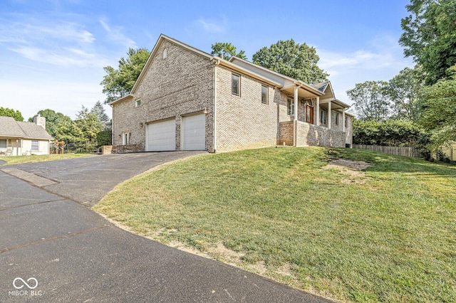 3766 Brill Rd, Indianapolis, IN 46227 - view of front of home featuring asphalt driveway, a garage, and brick siding