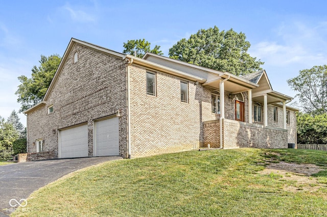 3766 Brill Rd, Indianapolis, IN 46227 - view of front of home with asphalt driveway, a front lawn, brick siding, and a garage