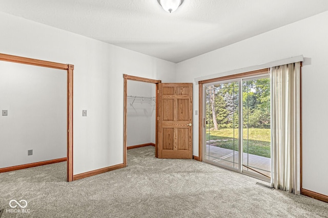 3766 Brill Rd, Indianapolis, IN 46227 - unfurnished bedroom featuring carpet, access to exterior, and a walk in closet