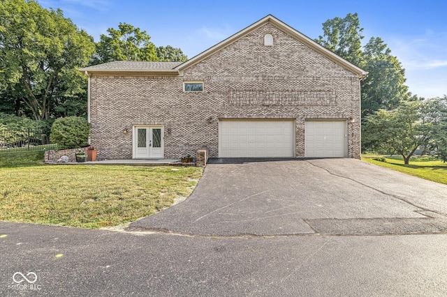 3766 Brill Rd, Indianapolis, IN 46227 - view of side of home featuring french doors, brick siding, driveway, and a lawn