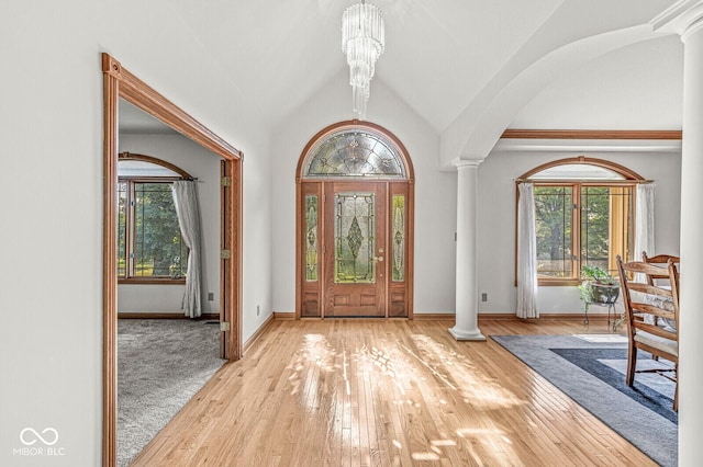 3766 Brill Rd, Indianapolis, IN 46227 - entrance foyer with decorative columns, hardwood / wood-style flooring, a chandelier, and lofted ceiling