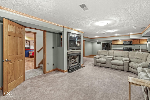 3766 Brill Rd, Indianapolis, IN 46227 - living area with ornamental molding, light carpet, stairway, a fireplace with flush hearth, and a textured ceiling
