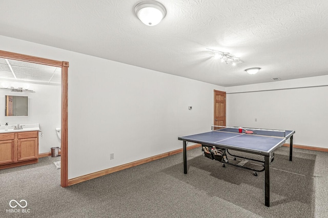 3766 Brill Rd, Indianapolis, IN 46227 - playroom featuring light carpet, a textured ceiling, and rail lighting