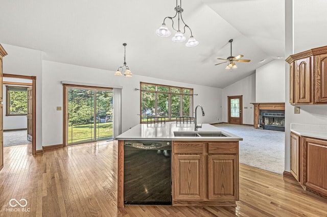 3766 Brill Rd, Indianapolis, IN 46227 - kitchen with dishwasher, a fireplace, a ceiling fan, open floor plan, and light wood-style floors