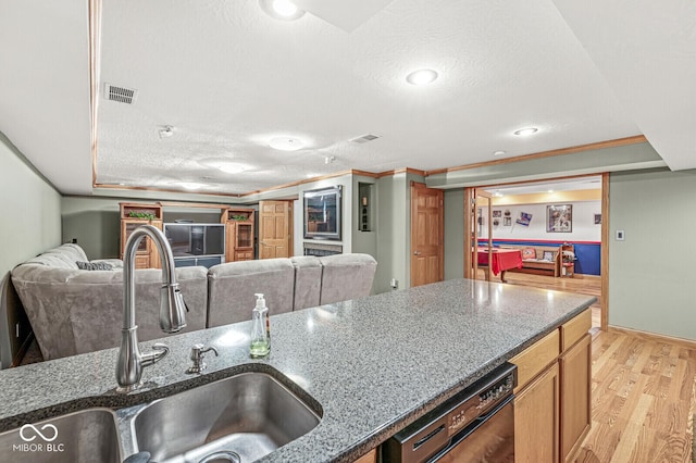 3766 Brill Rd, Indianapolis, IN 46227 - kitchen featuring dishwasher, a textured ceiling, dark stone countertops, light wood finished floors, and open floor plan