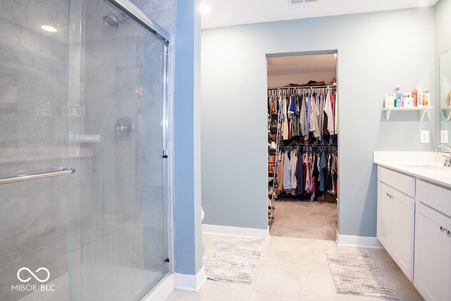 9309 Kellner St, Pendleton, IN 46064 - bathroom with vanity, a stall shower, a spacious closet, and tile patterned floors