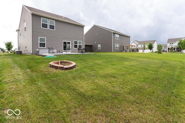 9309 Kellner St, Pendleton, IN 46064 - rear view of property with a fire pit and a lawn