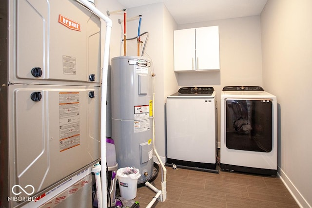 9309 Kellner St, Pendleton, IN 46064 - laundry area with electric water heater, washing machine and dryer, cabinet space, and heating unit
