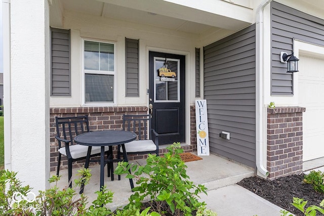 9309 Kellner St, Pendleton, IN 46064 - doorway to property featuring brick siding, a porch, and a garage