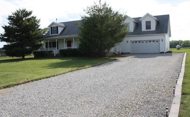 6052 N Deckshire Ln, Shirley, IN 47384 - cape cod house featuring gravel driveway, a garage, a front lawn, and covered porch