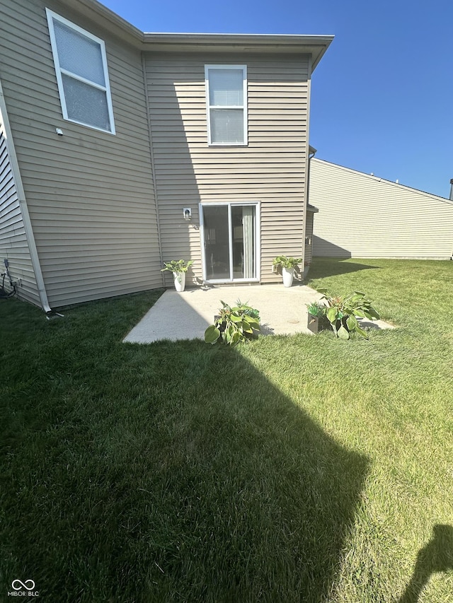 12536 Teacup Way NE, Indianapolis, IN 46235 - rear view of property featuring a patio area and a lawn