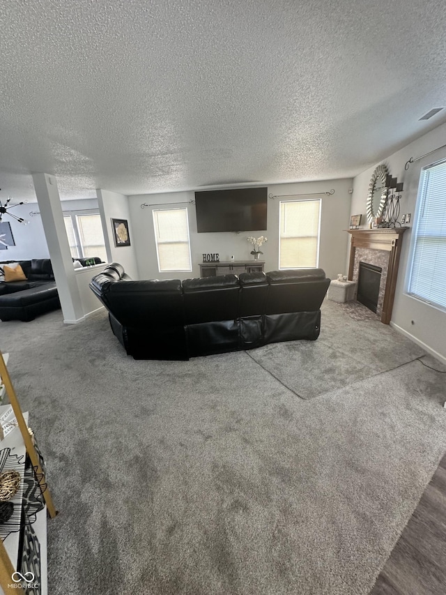 12536 Teacup Way NE, Indianapolis, IN 46235 - living room with a fireplace, a textured ceiling, and carpet floors
