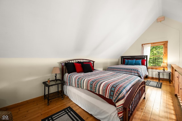 3715 Orchard Rd, Columbus, IN 47201 - bedroom featuring wood-type flooring, lofted ceiling, and radiator heating unit