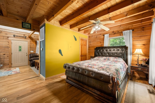 3715 Orchard Rd, Columbus, IN 47201 - bedroom with wooden walls, a wooden ceiling with exposed beams, and light wood-style flooring