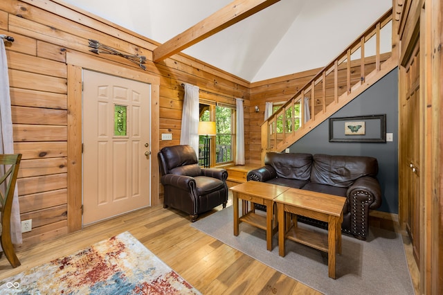 3715 Orchard Rd, Columbus, IN 47201 - living room with light wood finished floors, stairs, lofted ceiling, and wooden walls