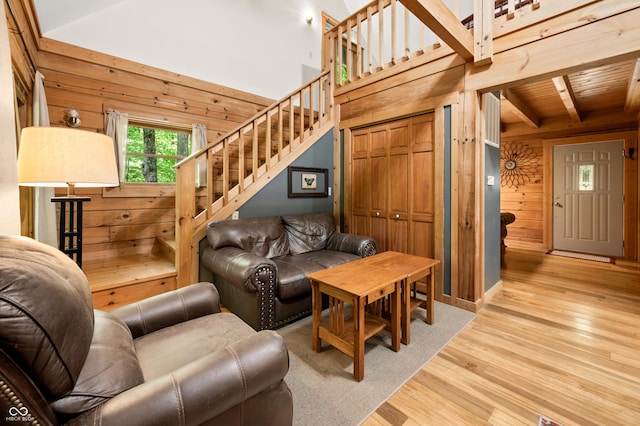 3715 Orchard Rd, Columbus, IN 47201 - living area featuring wood walls, wood finished floors, a wooden ceiling with exposed beams, and stairway