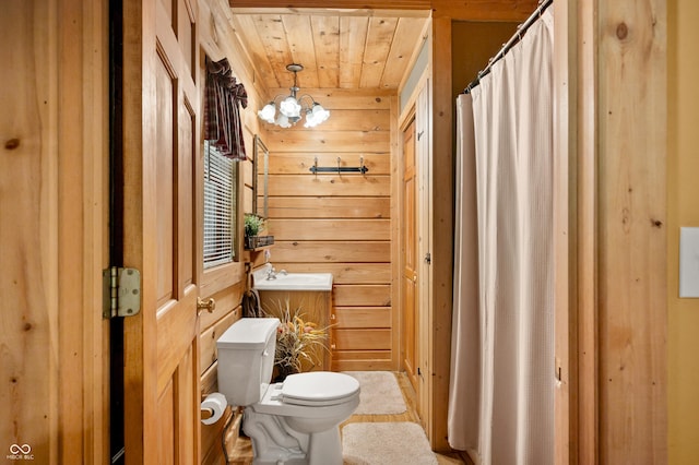 3715 Orchard Rd, Columbus, IN 47201 - bathroom with wooden ceiling, wood walls, vanity, and a chandelier