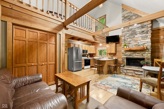 3715 Orchard Rd, Columbus, IN 47201 - living area featuring high vaulted ceiling, light wood-style floors, a fireplace, and wooden walls