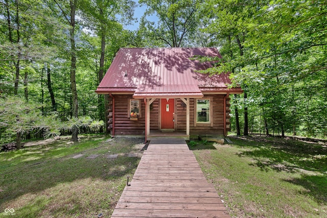 3715 Orchard Rd, Columbus, IN 47201 - view of front of home featuring log exterior, a metal roof, and a front yard