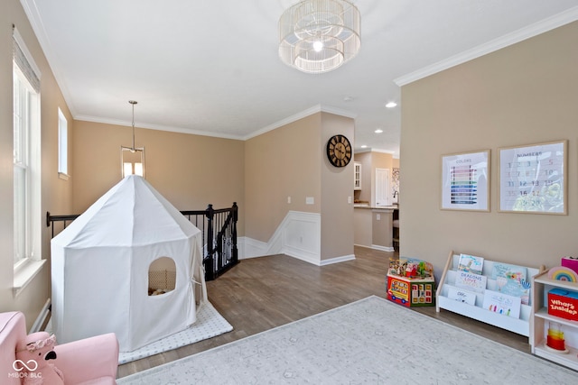 9476 Oakley Dr, Indianapolis, IN 46260 - rec room with wood finished floors, a chandelier, ornamental molding, and recessed lighting