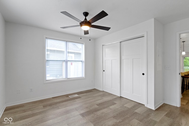 4129 Cornelius Ave, Indianapolis, IN 46208 - unfurnished bedroom with light wood-style flooring, a closet, and a ceiling fan
