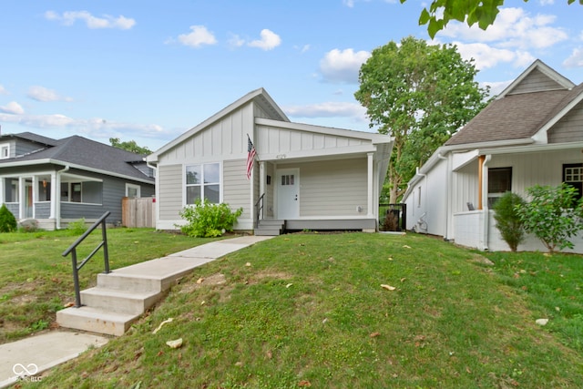 4129 Cornelius Ave, Indianapolis, IN 46208 - view of front facade featuring board and batten siding and a front yard
