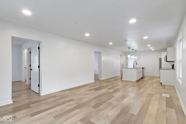 4129 Cornelius Ave, Indianapolis, IN 46208 - unfurnished living room with recessed lighting and light wood-type flooring