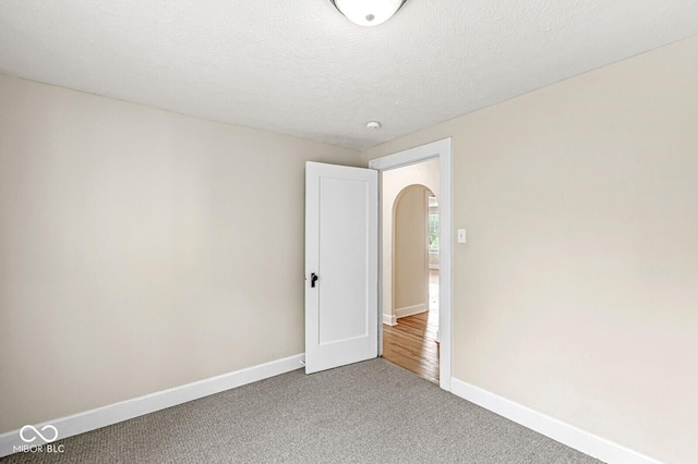 3760 Brill Rd, Indianapolis, IN 46227 - carpeted empty room with baseboards and arched walkways