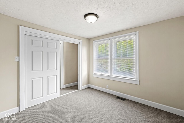 3760 Brill Rd, Indianapolis, IN 46227 - unfurnished bedroom with carpet floors, a closet, and a textured ceiling