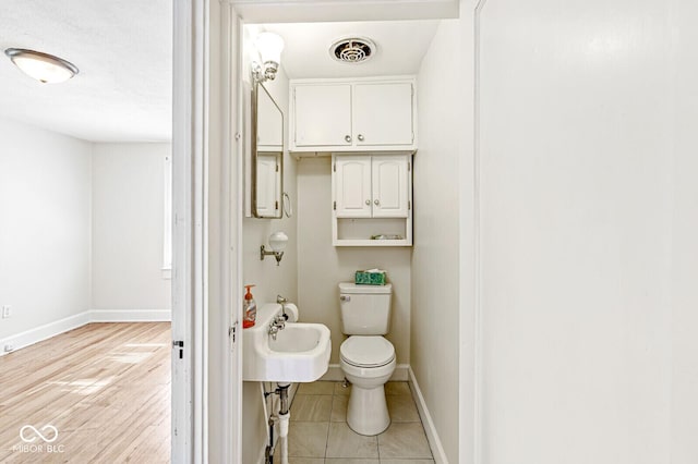 3760 Brill Rd, Indianapolis, IN 46227 - bathroom featuring toilet and wood finished floors