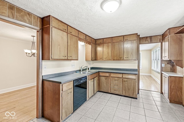 3760 Brill Rd, Indianapolis, IN 46227 - kitchen with dishwasher, a chandelier, light tile patterned floors, a textured ceiling, and dark countertops