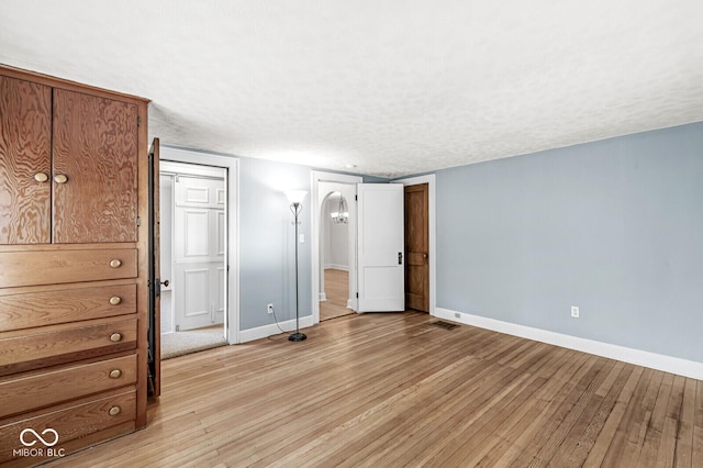 3760 Brill Rd, Indianapolis, IN 46227 - unfurnished bedroom with light wood-style floors and a textured ceiling
