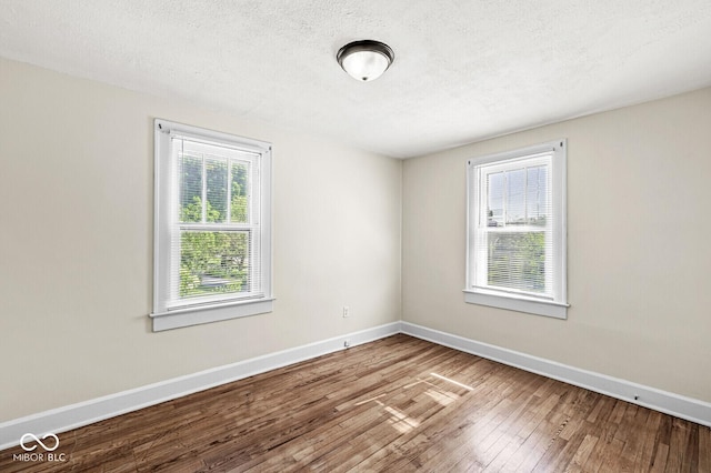 3760 Brill Rd, Indianapolis, IN 46227 - empty room featuring hardwood / wood-style floors and a textured ceiling