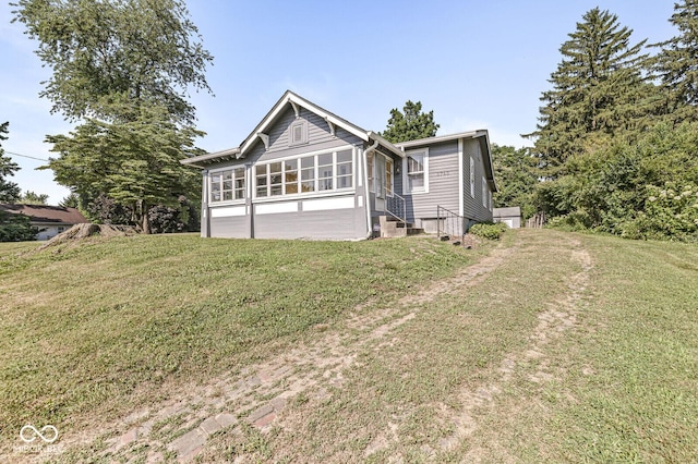 3760 Brill Rd, Indianapolis, IN 46227 - view of front of property featuring a sunroom, a front yard, and entry steps