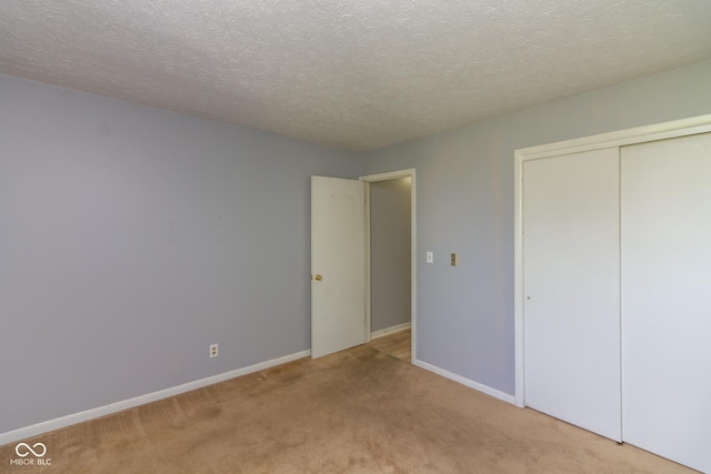 951 W Mckay Rd, Shelbyville, IN 46176 - unfurnished bedroom featuring carpet flooring, a textured ceiling, and a closet
