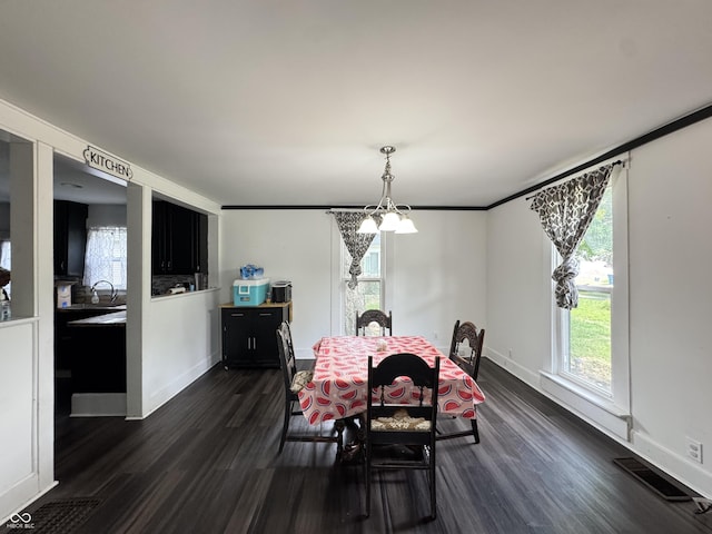 817 Pearl St, Covington, IN 47932 - dining room featuring dark wood-style floors and a chandelier