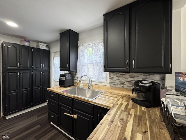 817 Pearl St, Covington, IN 47932 - kitchen featuring wooden counters, dark cabinetry, dark wood-style floors, and decorative backsplash