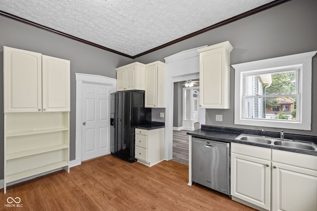 761 N Holmes Ave, Indianapolis, IN 46222 - kitchen featuring dishwasher, black fridge, crown molding, light wood-style flooring, and dark countertops
