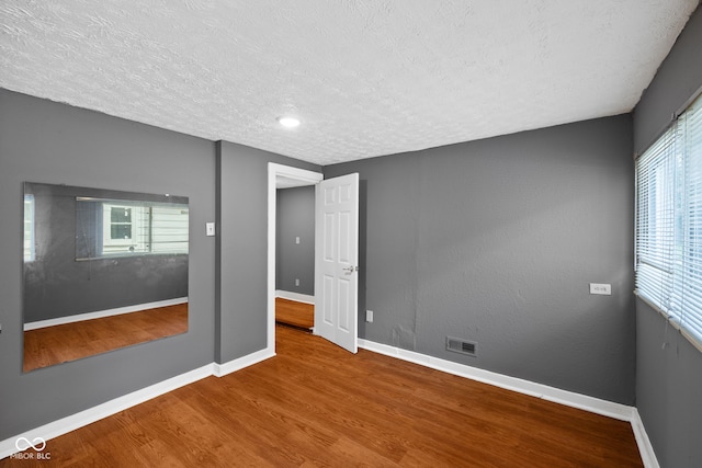 761 N Holmes Ave, Indianapolis, IN 46222 - unfurnished room featuring wood finished floors and a textured ceiling