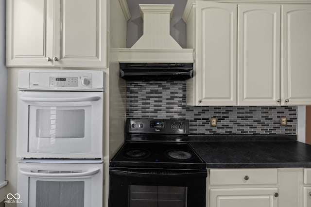 761 N Holmes Ave, Indianapolis, IN 46222 - kitchen featuring black electric range oven, white double oven, custom exhaust hood, dark countertops, and backsplash
