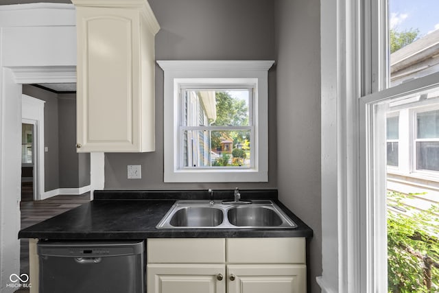 761 N Holmes Ave, Indianapolis, IN 46222 - kitchen with dishwashing machine, dark countertops, white cabinets, and wood finished floors