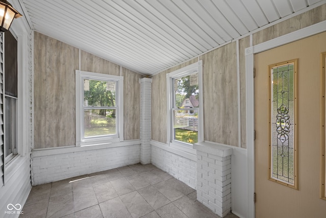 761 N Holmes Ave, Indianapolis, IN 46222 - unfurnished sunroom featuring healthy amount of natural light, lofted ceiling, and wood walls