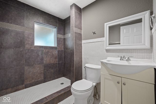 761 N Holmes Ave, Indianapolis, IN 46222 - bathroom with vanity, a tile shower, tile walls, and tile patterned flooring