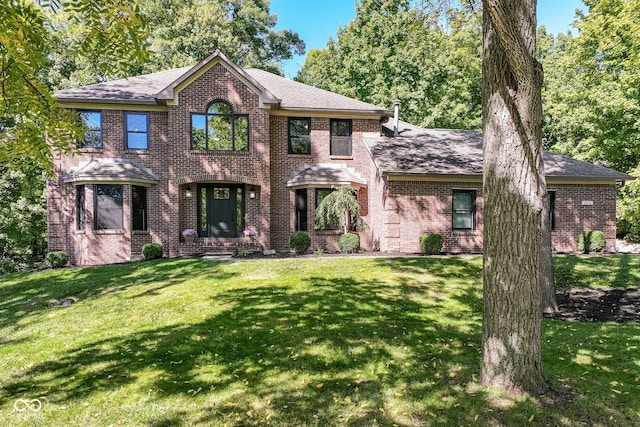 5826 Winding Way Ln, Indianapolis, IN 46220 - view of front facade with brick siding, a front yard, and a shingled roof
