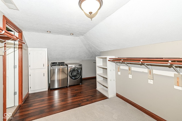 5826 Winding Way Ln, Indianapolis, IN 46220 - spacious closet featuring washer and dryer, vaulted ceiling, dark colored carpet, and dark wood-style flooring