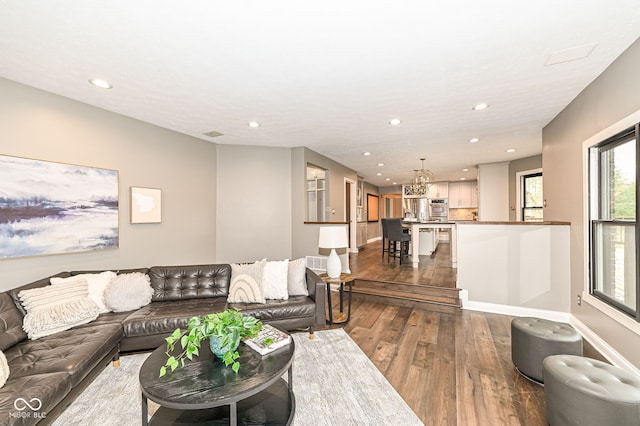 5826 Winding Way Ln, Indianapolis, IN 46220 - living room featuring dark wood-style flooring, recessed lighting, and a chandelier